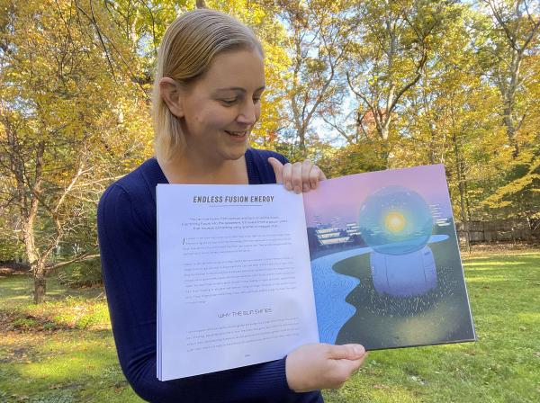 Portrait of Kathryn Hulik in back yard with book open to page on fusion