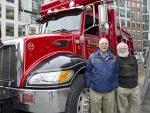 Dan Cohn and Leslie Bromberg stand next to a red 