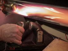 Hand holds a magnet under a plasma demo device