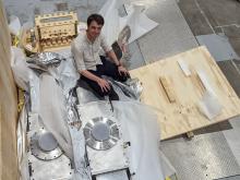 Photo of Jack Hare from above surrounded by research materials