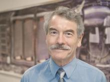 Ian Hutchinson in front of image of C-Mod antennae