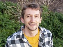 Photo of Ben Reichelt near greenery on MIT campus.